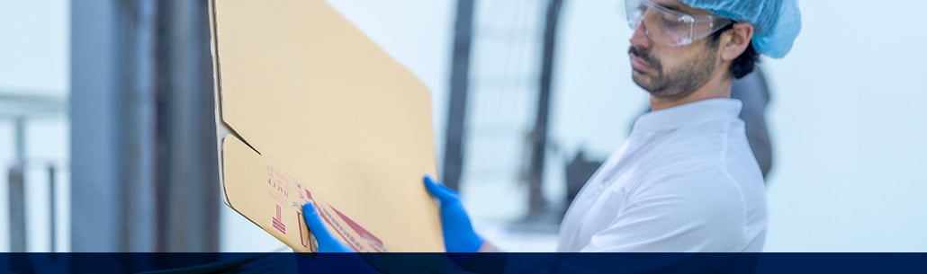 compliance inspector inspecting boxes at the food processing facility