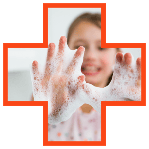 A kid holding hands with soap lathered up