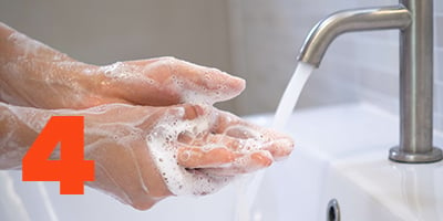 A person washing hands with soap