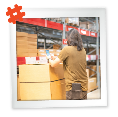 grocery employee performing inventory in the back of the house