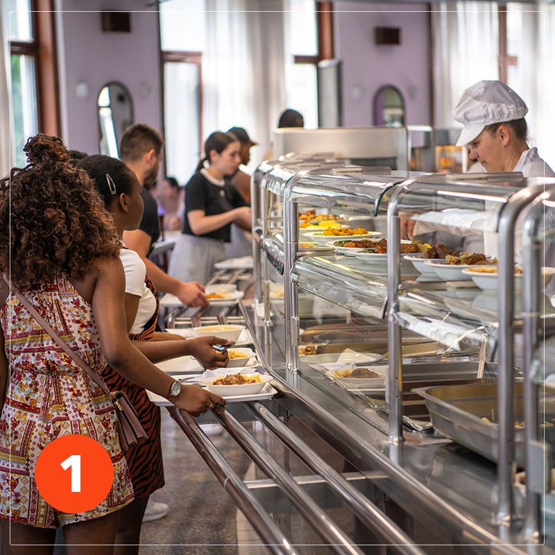students lined up at the lunch counter in school cafeteria