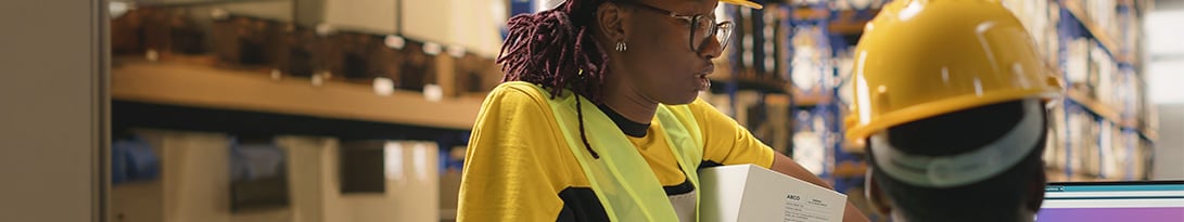 warehouse worker talking to operational manager
