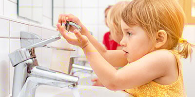 children washing hands after using restroom
