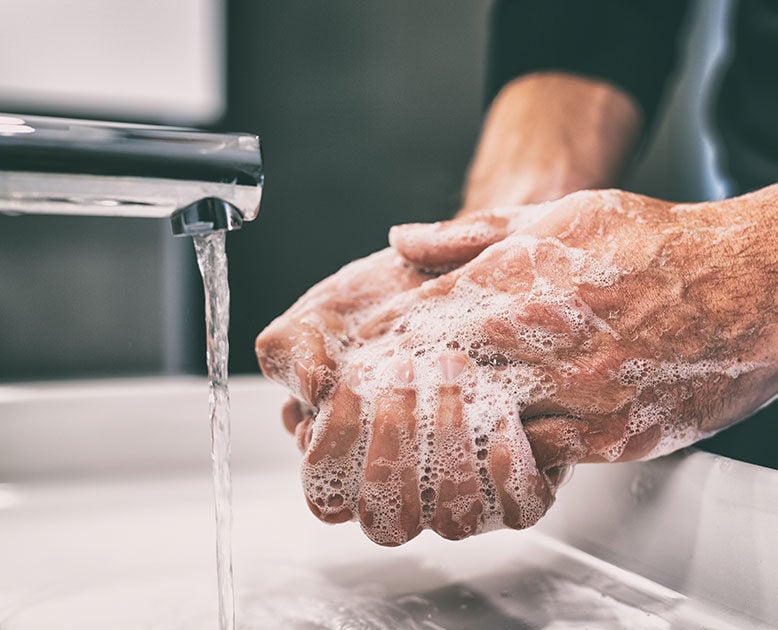 person washing hands with soap