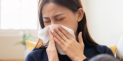 person blowing nose