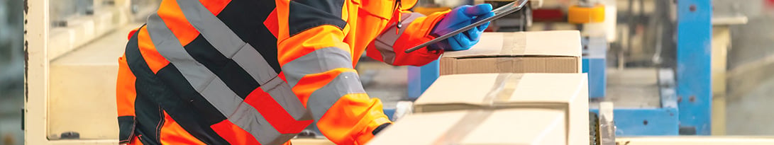 warehouse worker checking for standardization of packaging