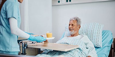 a senior patient receiving room-service style meal service