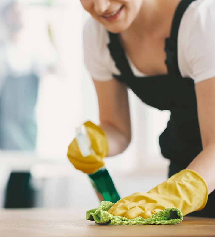 a custodian using green cleaning chemical