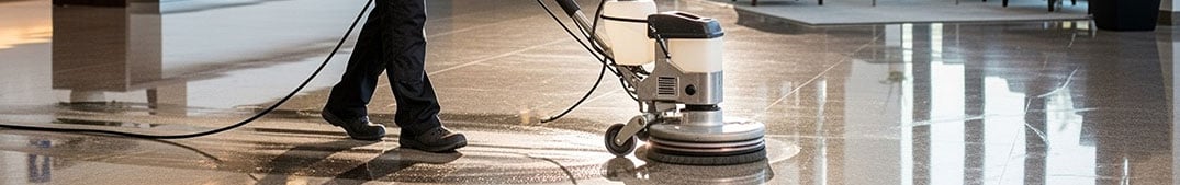 comprehensive surface cleaning - person using floor scrubber to clean the floor