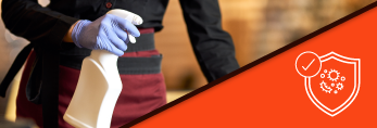 restaurant staff using disinfection to clean table