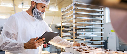 kitchen staff inspecting for food safety