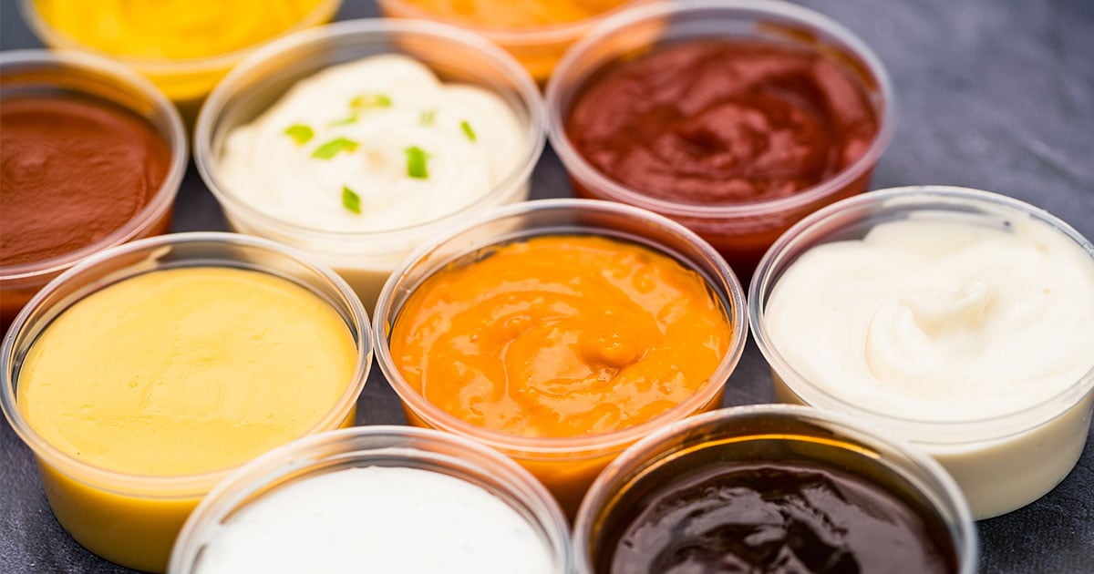 various types of condiments in portion cups
