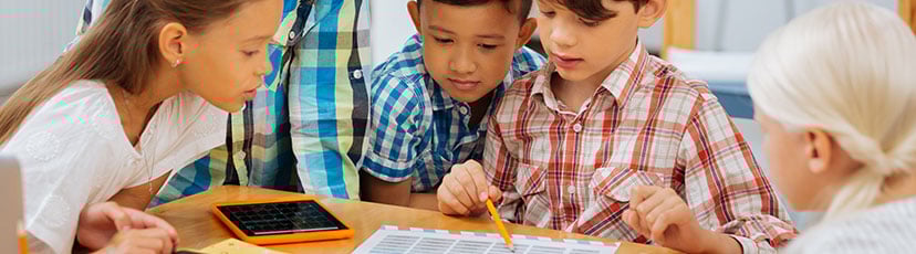 students gathered and working on project together at school