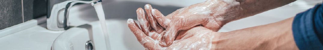 a person washing hands with soap - hand hygiene