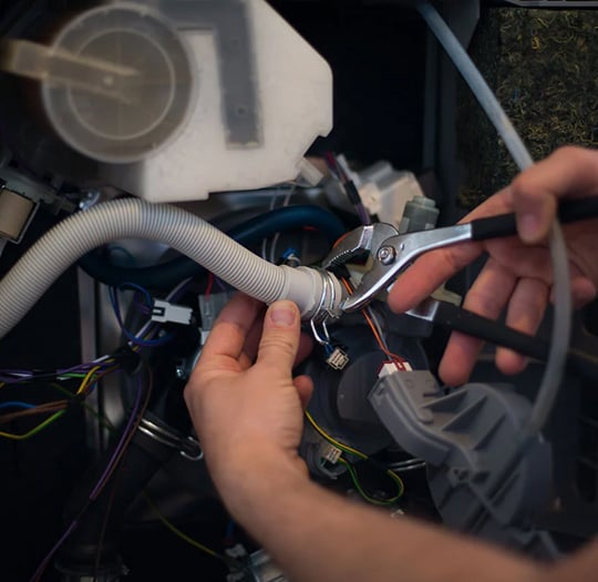 technician repairing cleaning equipment